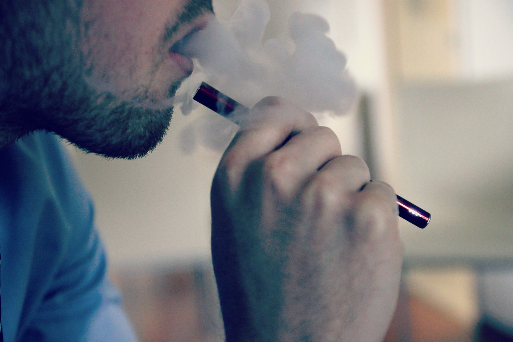 Man exhaling vapor from an e-cigarette