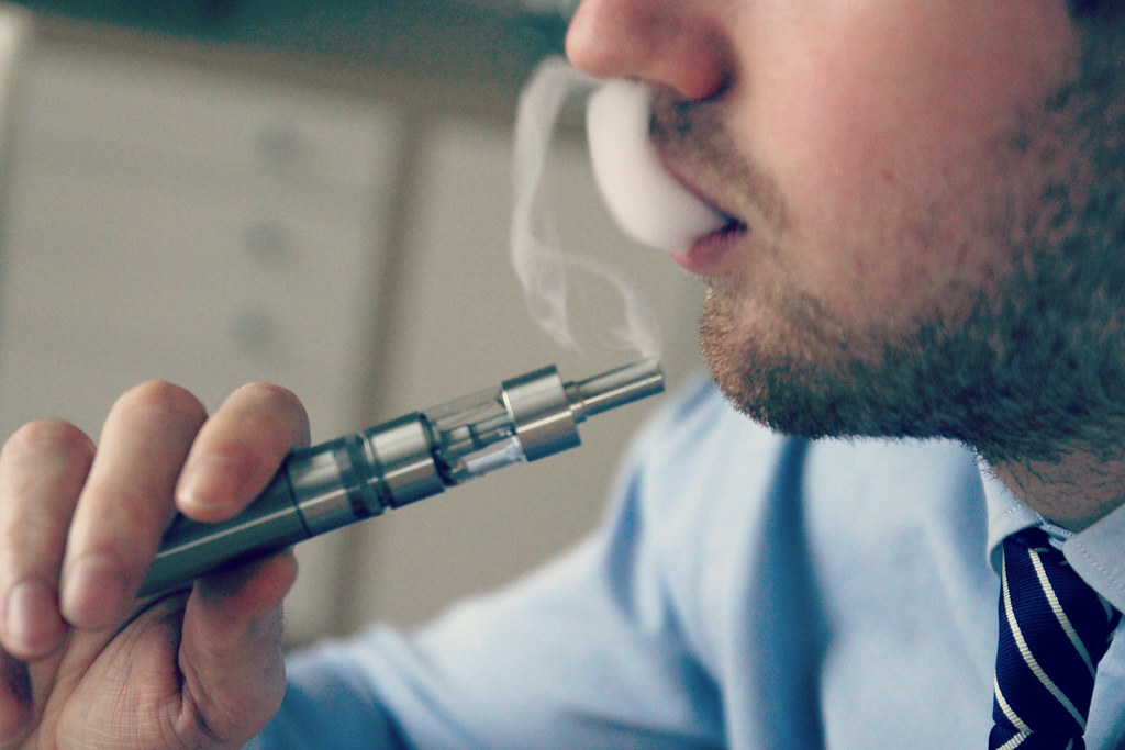 Man exhaling vapor from an e-cigarette