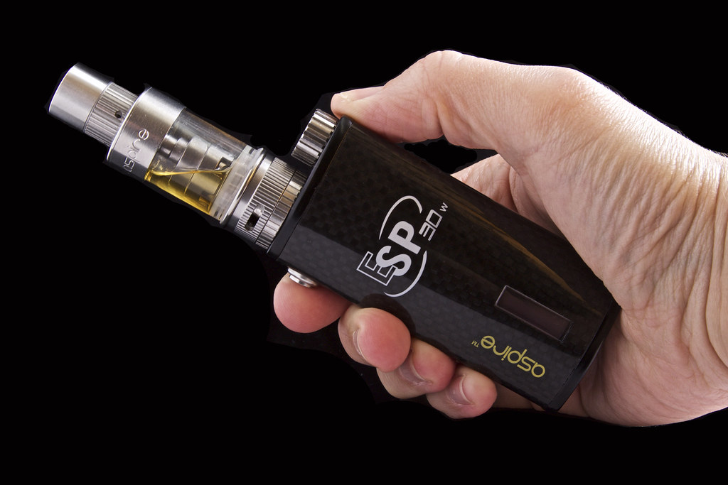 Hand holding a box mod vape